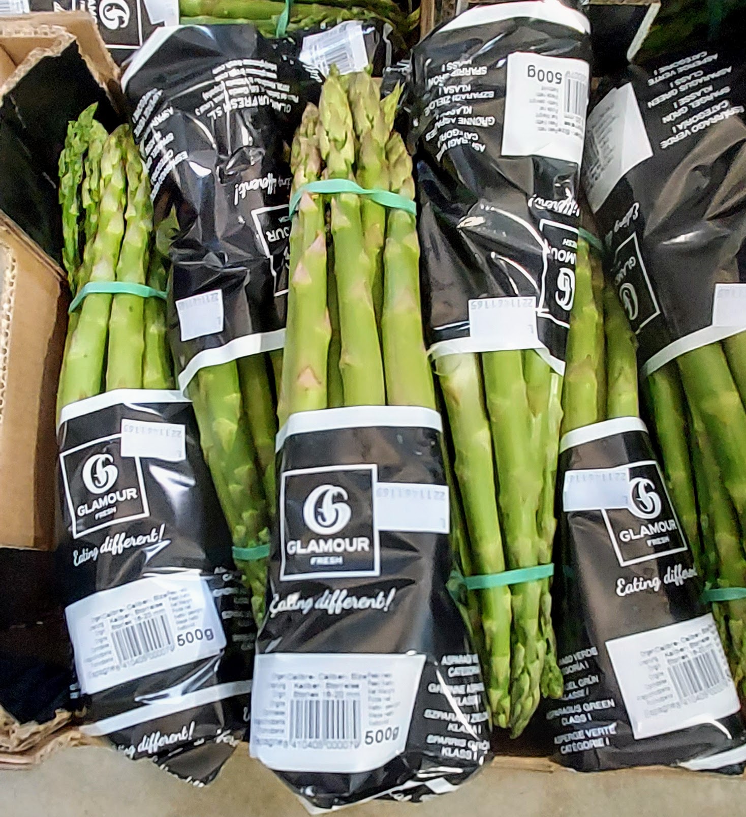 Asparagus bundles in wrappers.